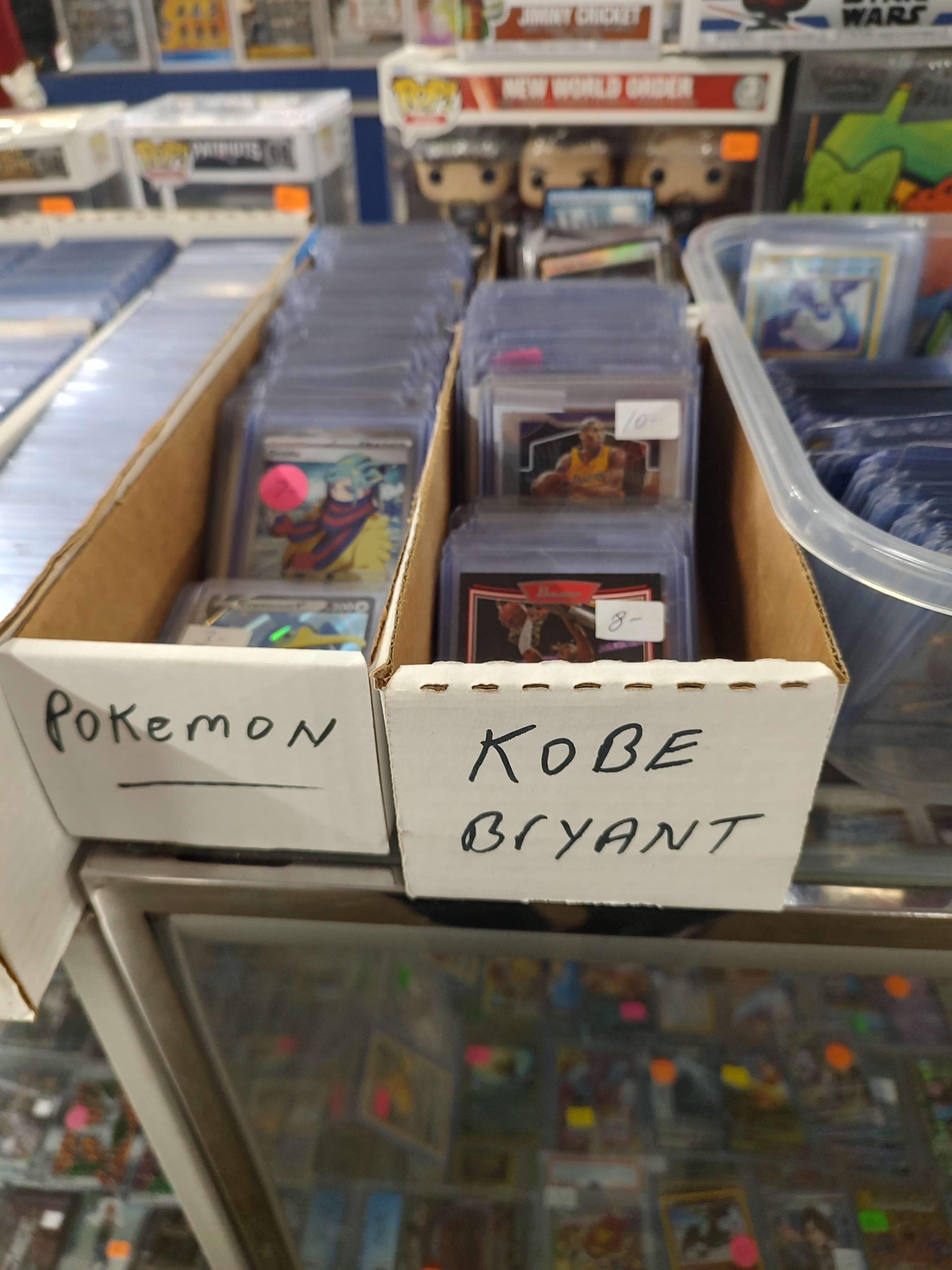 boxes of cards labelled 'pokemon' and 'kobe bryant'